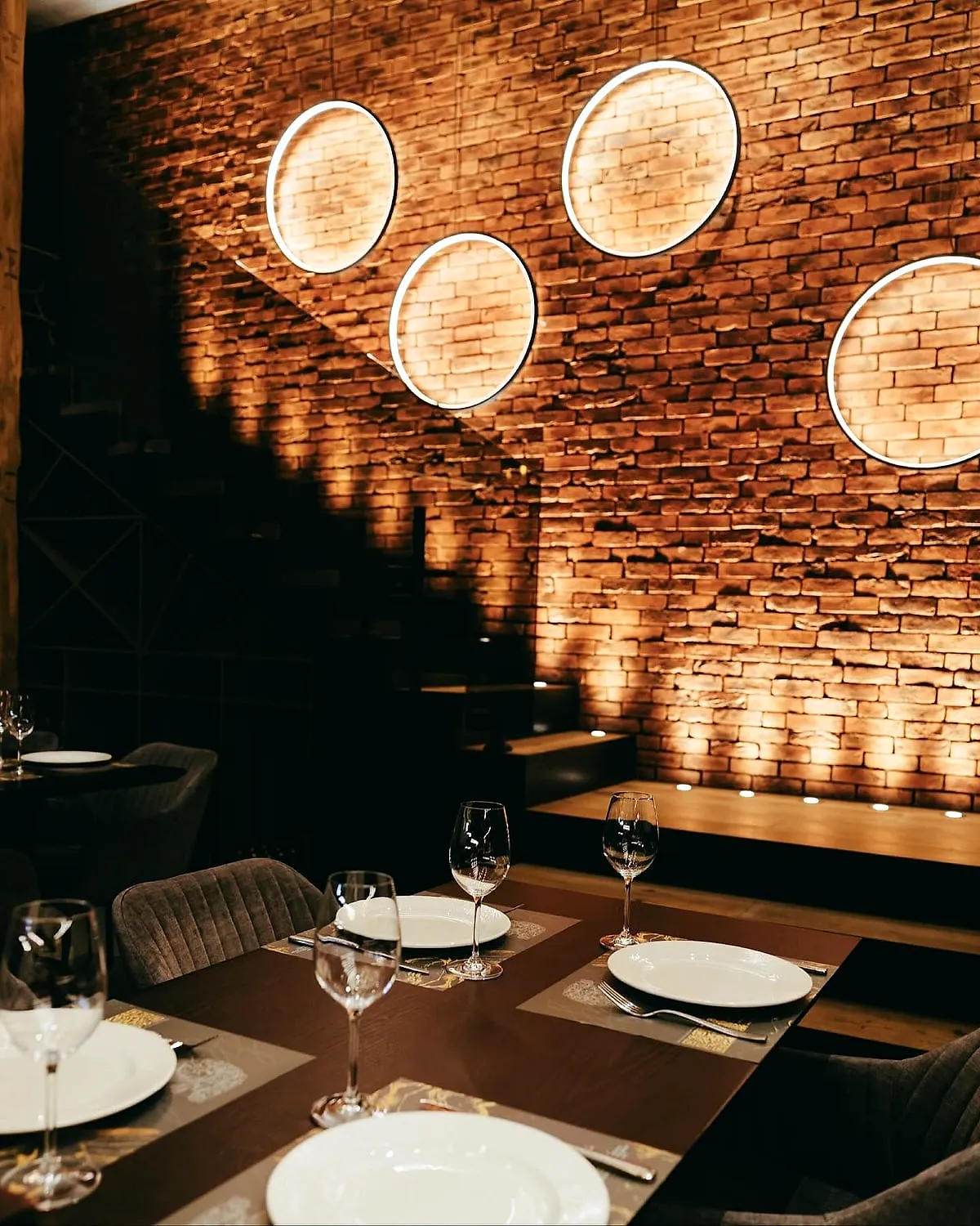 Brick wall with round lights and set tables