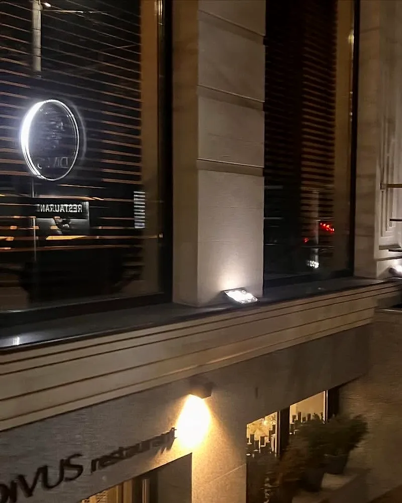 The round Bacchus sign at the restaurant entrance, at night